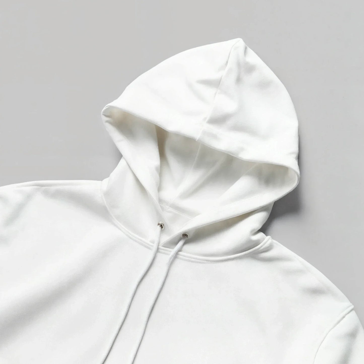 Unisex white hoodie with drawstrings, minimalist streetwear flat lay on gray background